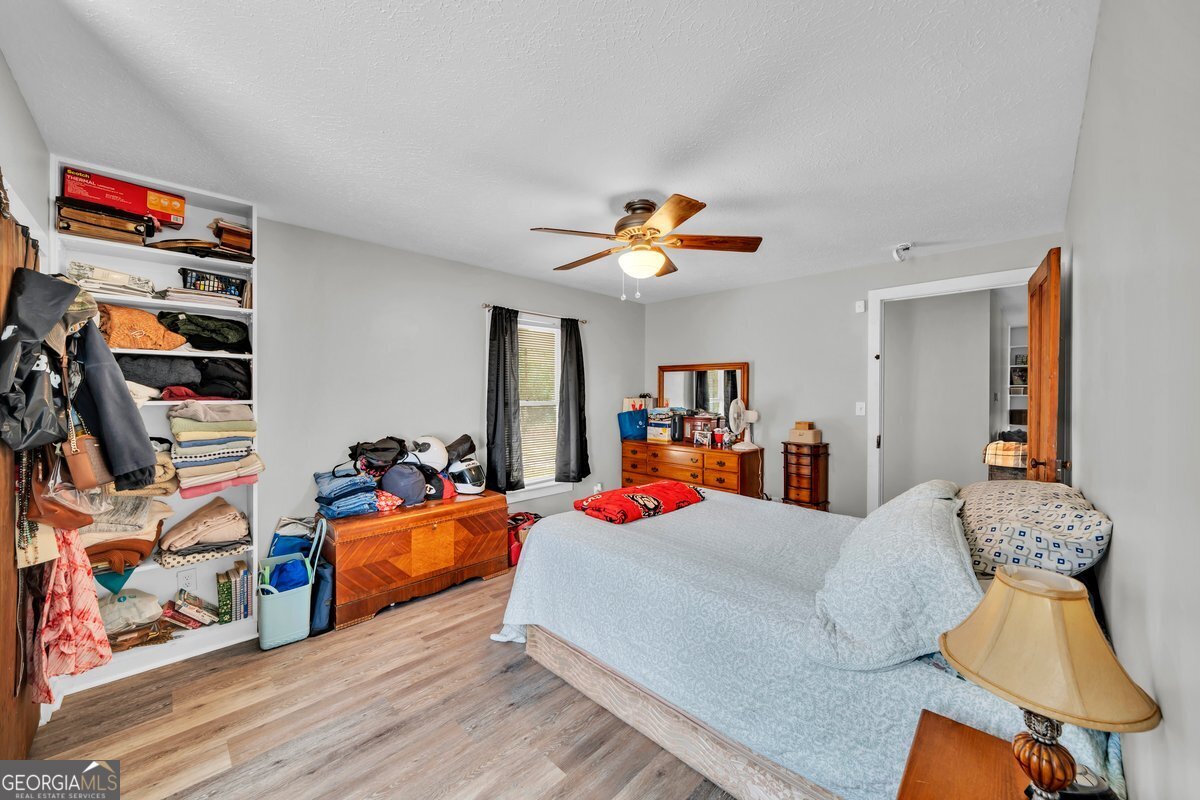 418 Flintside Drive Cobb, GA 31735 - Photo 22 of 45 a bedroom with furniture and a flat screen tv