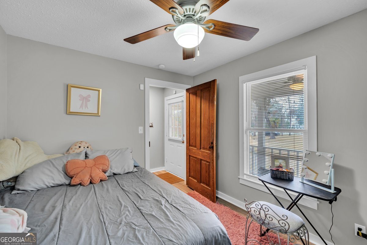 418 Flintside Drive Cobb, GA 31735 - Photo 25 of 45 a bedroom with a bed and wooden floor