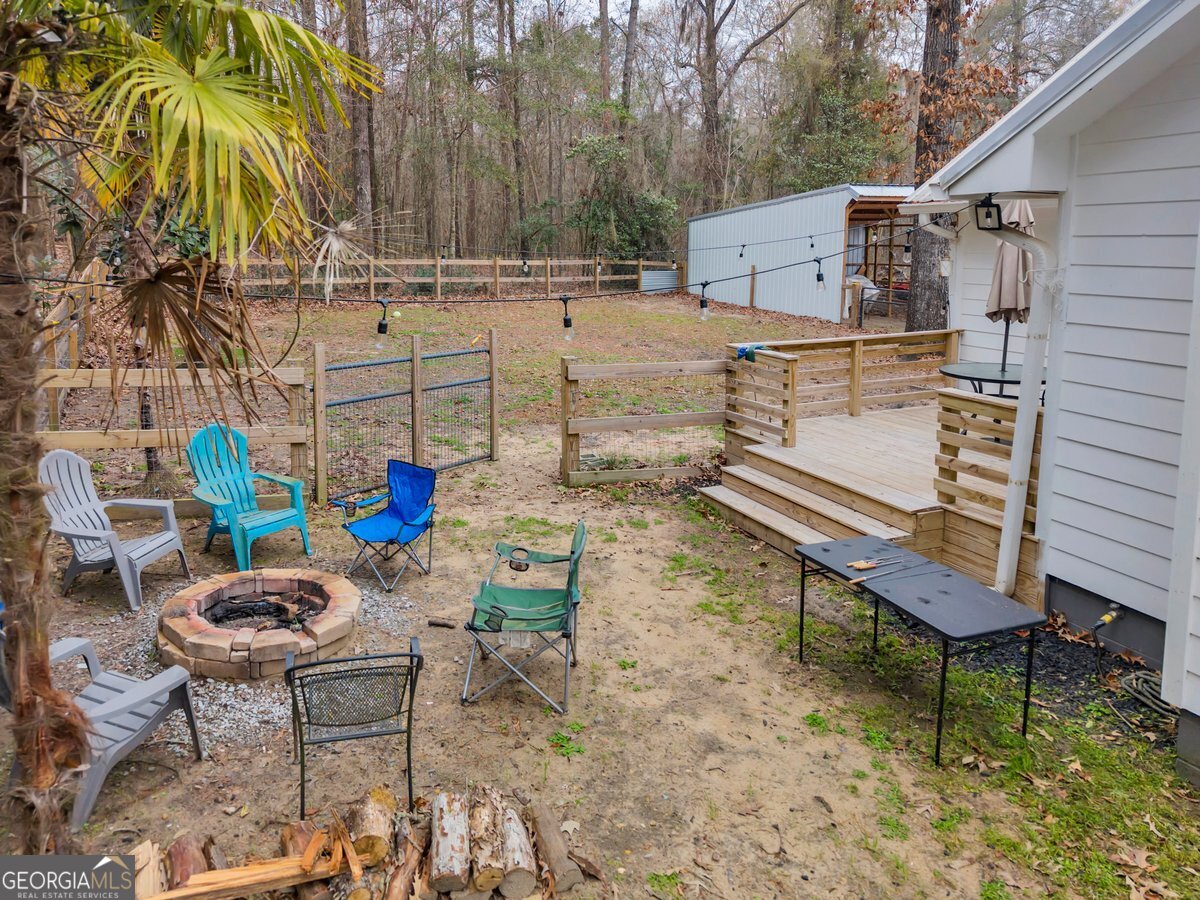 418 Flintside Drive Cobb, GA 31735 - Photo 27 of 45 a view of a chairs and table in backyard
