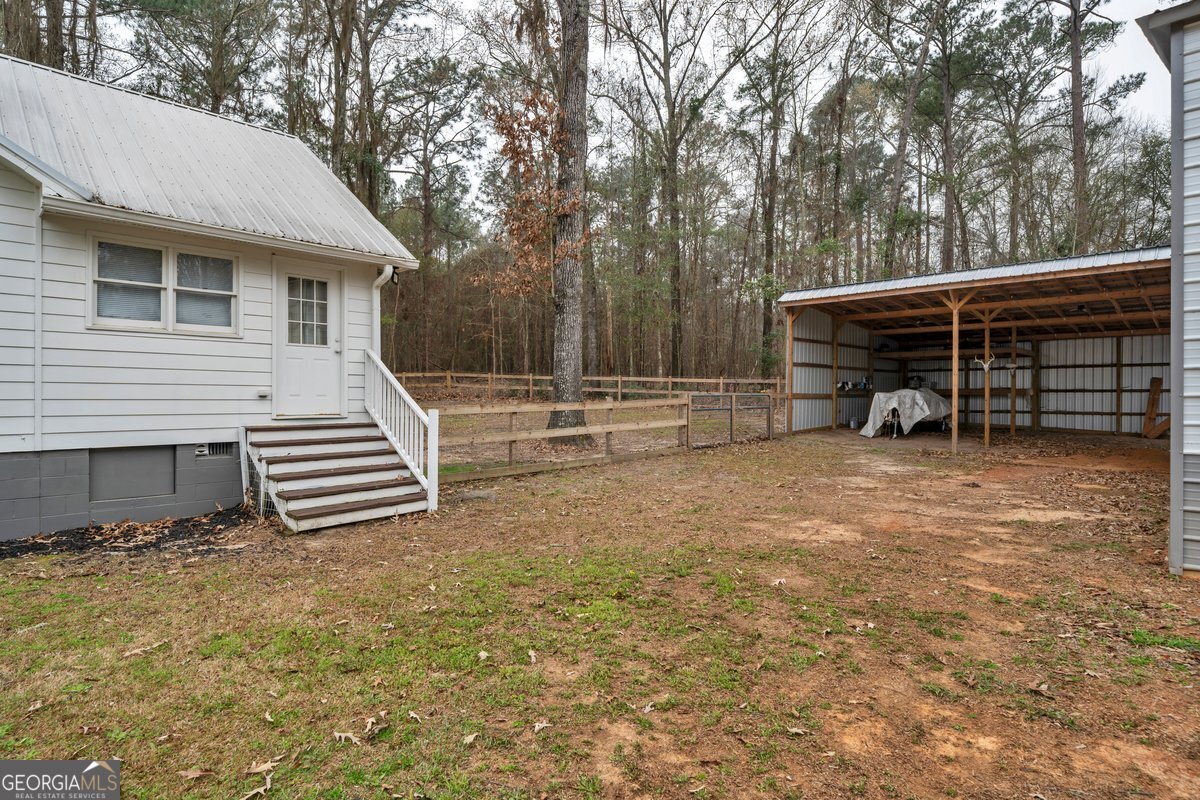 418 Flintside Drive Cobb, GA 31735 - Photo 32 of 45 a view of a house with backyard and trees