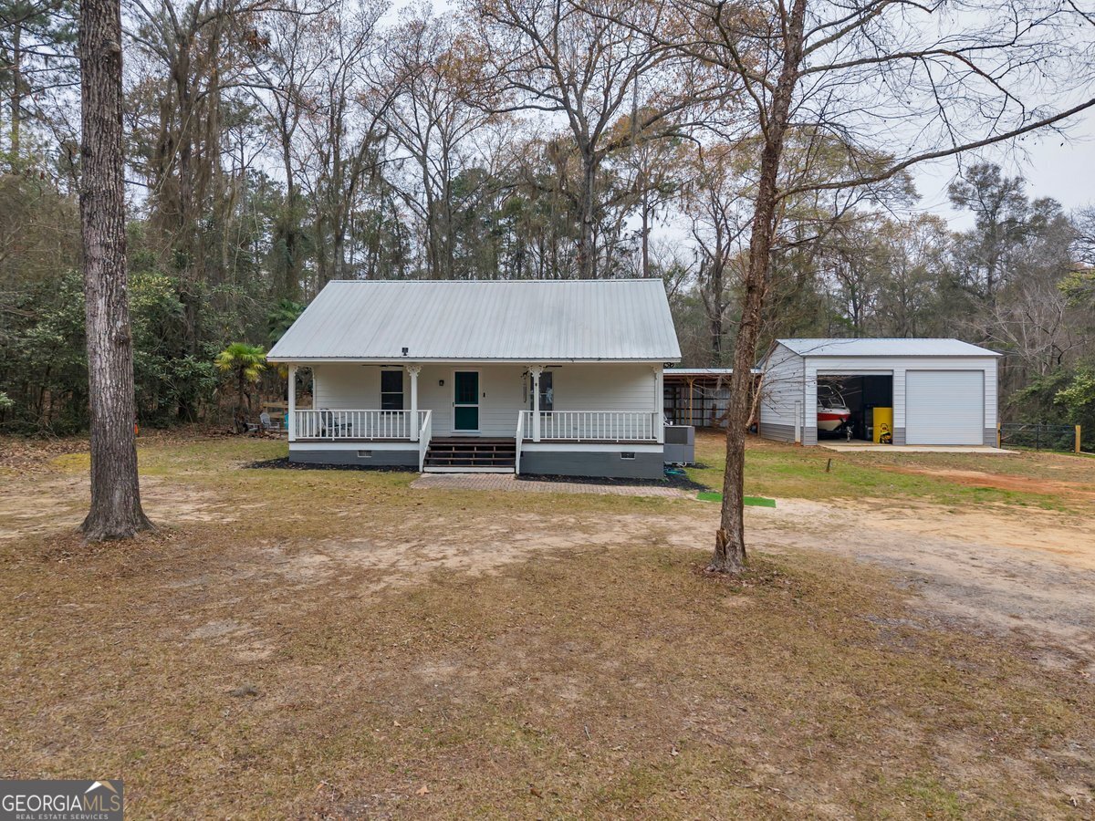 418 Flintside Drive Cobb, GA 31735 - Photo 4 of 45 a house with trees in front of it