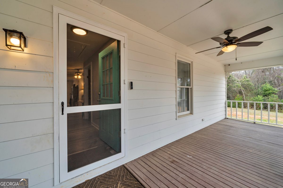 418 Flintside Drive Cobb, GA 31735 - Photo 5 of 45 a view of a hallway with wooden floor and a ceiling fan