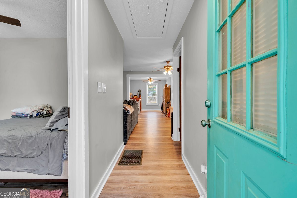 418 Flintside Drive Cobb, GA 31735 - Photo 6 of 45 a view of a hallway with wooden floor and staircase