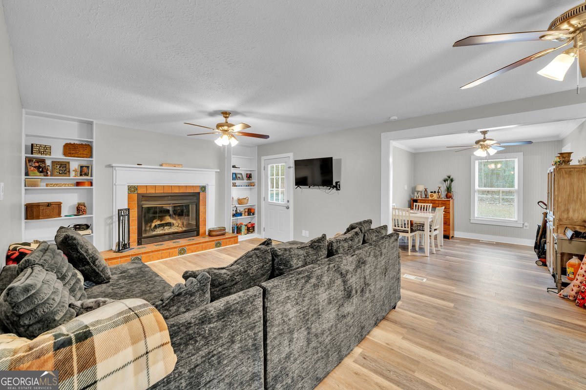 418 Flintside Drive Cobb, GA 31735 - Photo 7 of 45 a living room with furniture and a fireplace