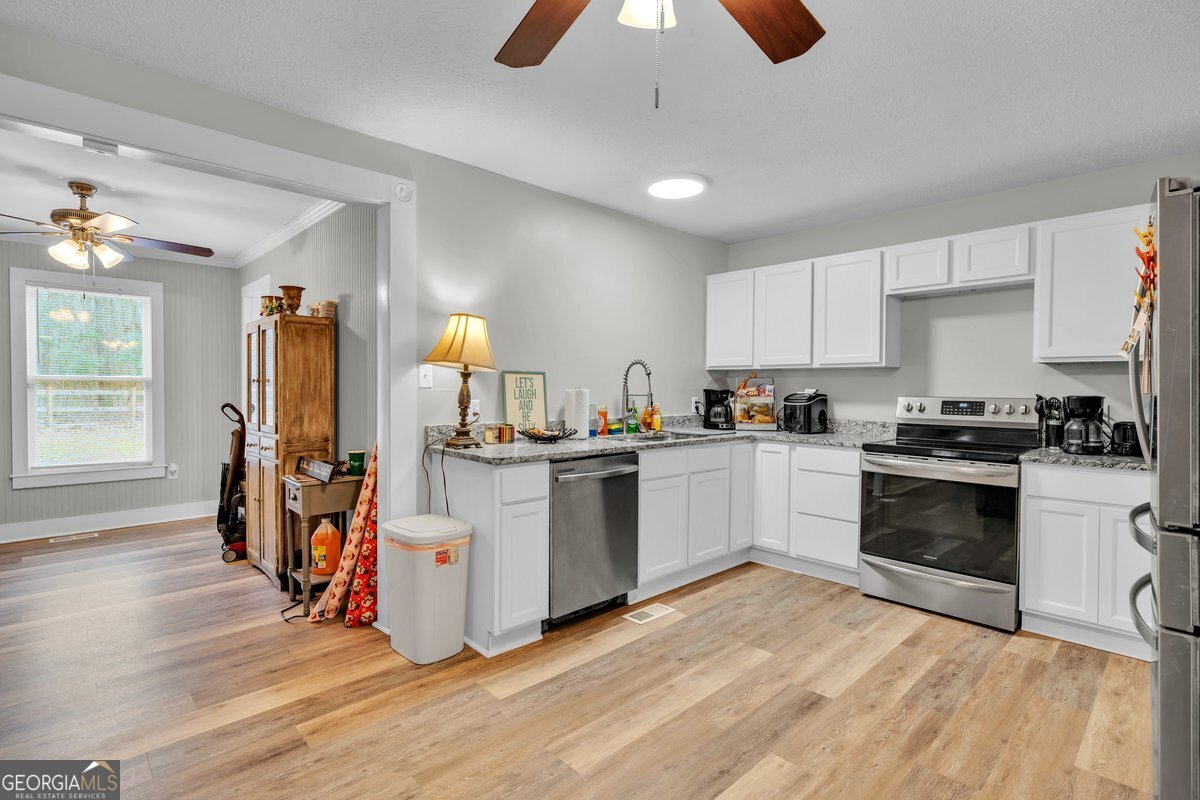 418 Flintside Drive Cobb, GA 31735 - Photo 8 of 45 a kitchen with a sink appliances and cabinets