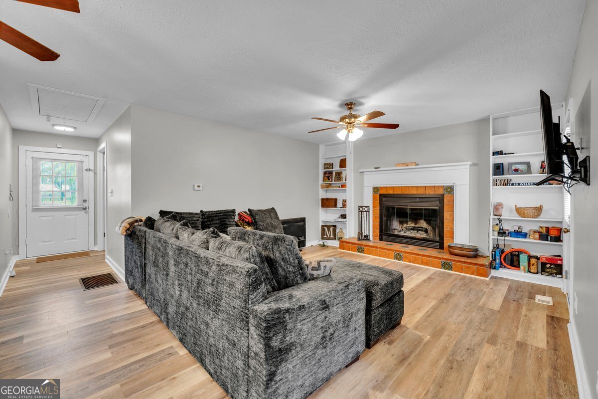 418 Flintside Drive Cobb, GA 31735 - Photo 9 of 45 a living room with furniture and a fireplace