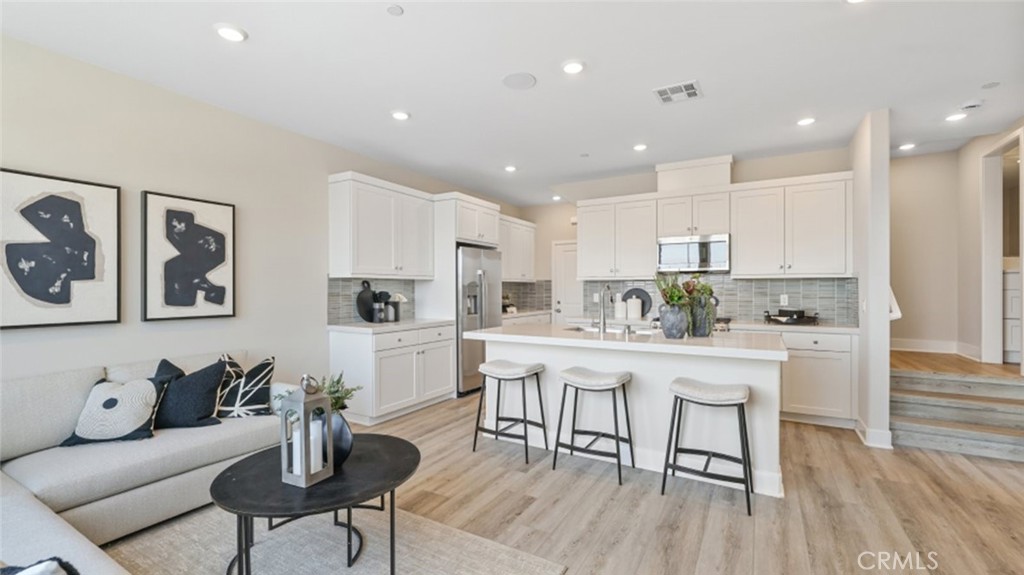 474 Lobata Irvine, CA 92618 - Photo 11 of 43 a kitchen with stainless steel appliances granite countertop a stove a sink and a refrigerator