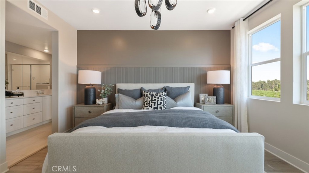 474 Lobata Irvine, CA 92618 - Photo 14 of 43 a bedroom with a large bed and a table