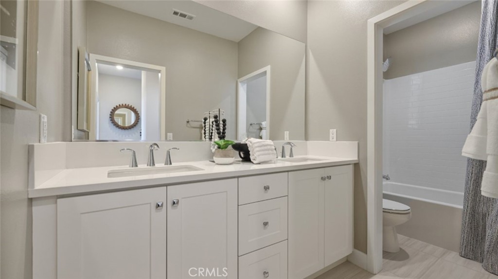 474 Lobata Irvine, CA 92618 - Photo 20 of 43 a bathroom with a sink and a mirror