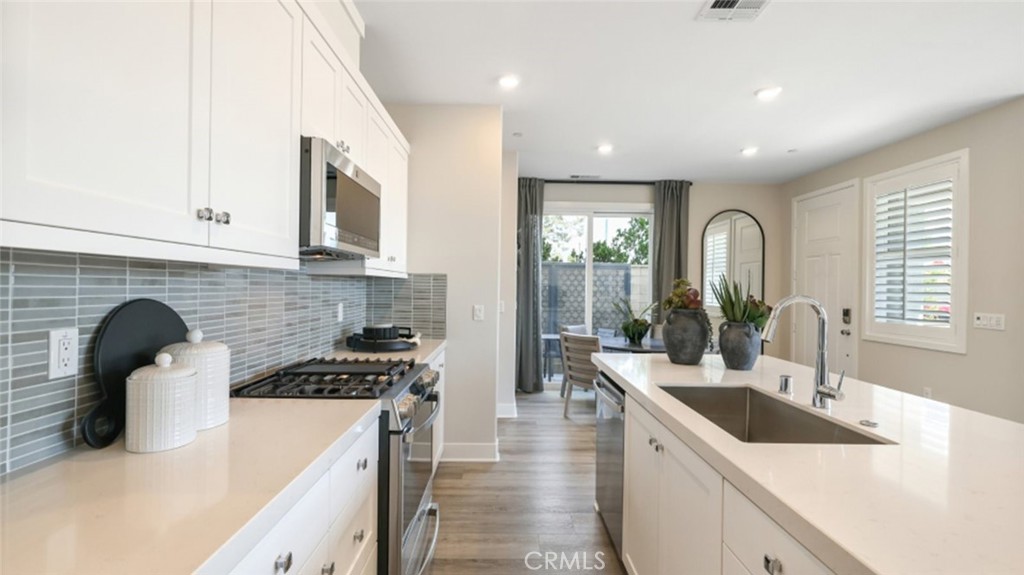 474 Lobata Irvine, CA 92618 - Photo 2 of 43 a kitchen with a sink a stove and cabinets