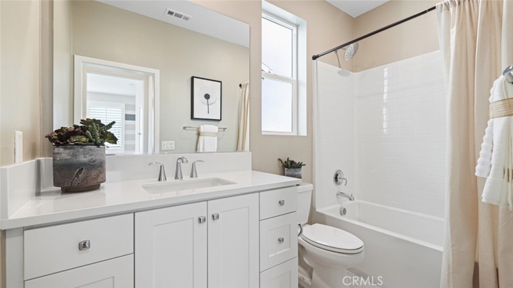 474 Lobata Irvine, CA 92618 - Photo 23 of 43 a bathroom with a double vanity sink toilet mirror and shower