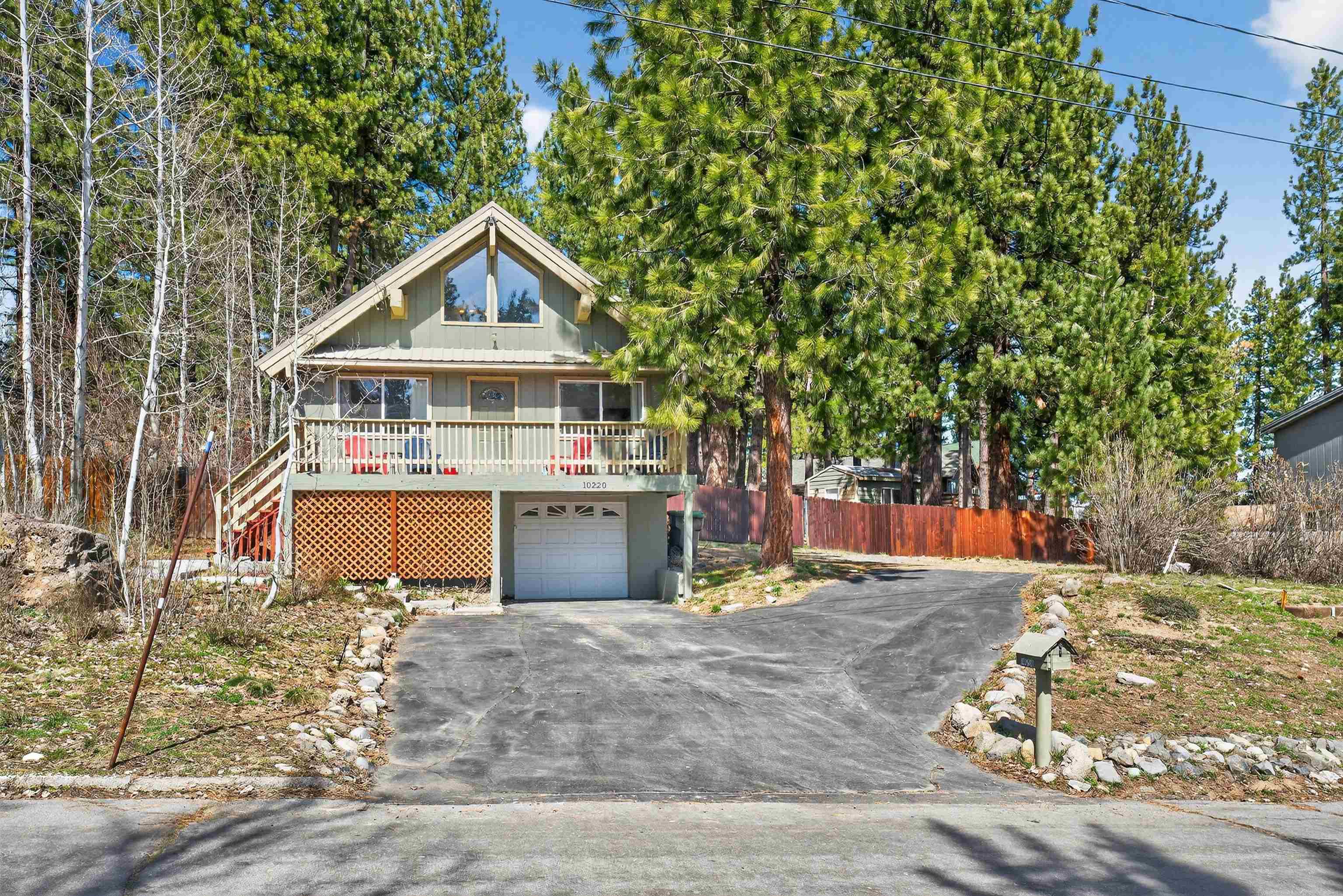 a view of a house with a yard and sitting area