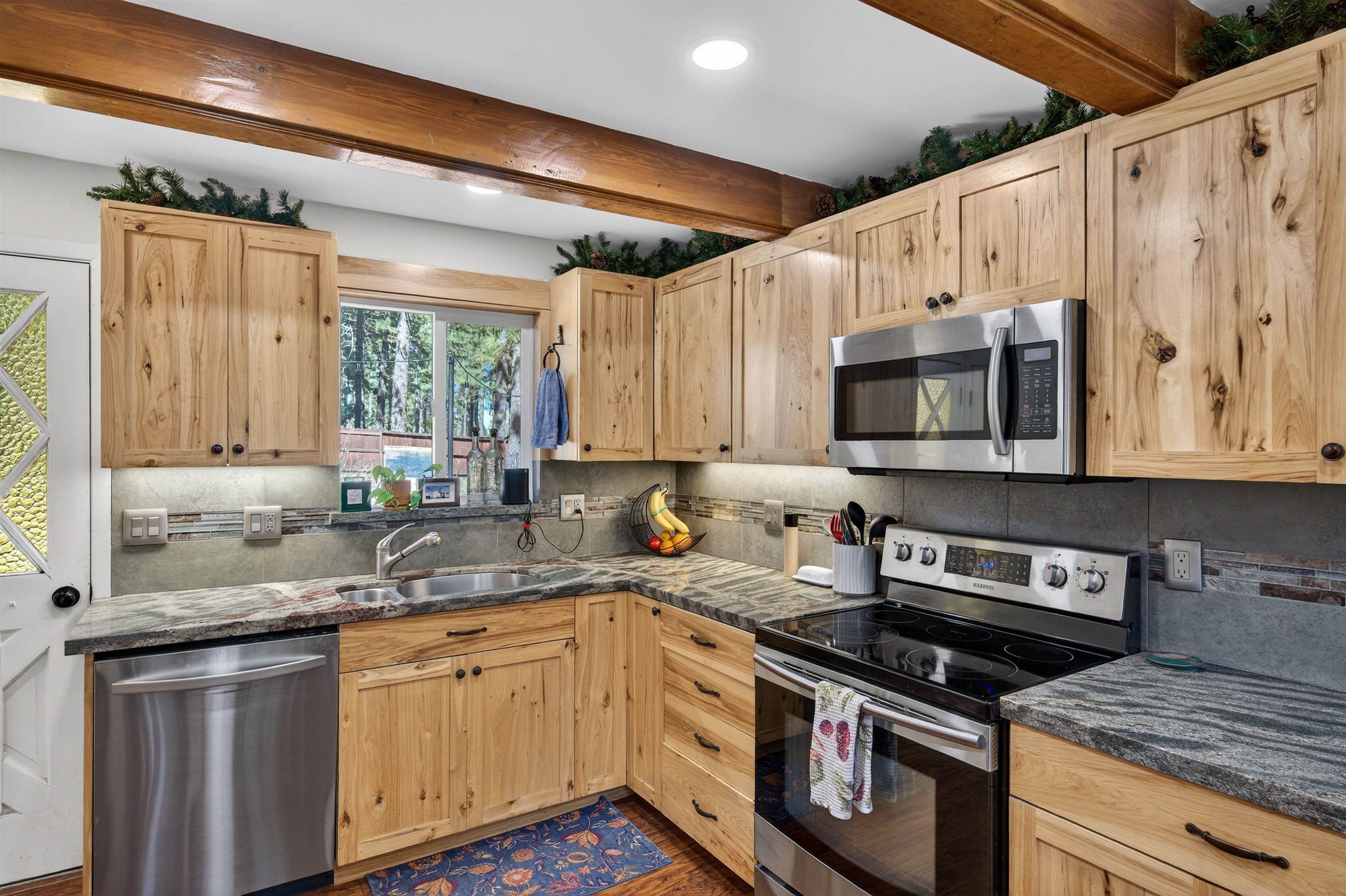 10220 Columbine Road Truckee, CA 96161 - Photo 11 of 28 a kitchen with stainless steel appliances granite countertop a stove a sink and a microwave