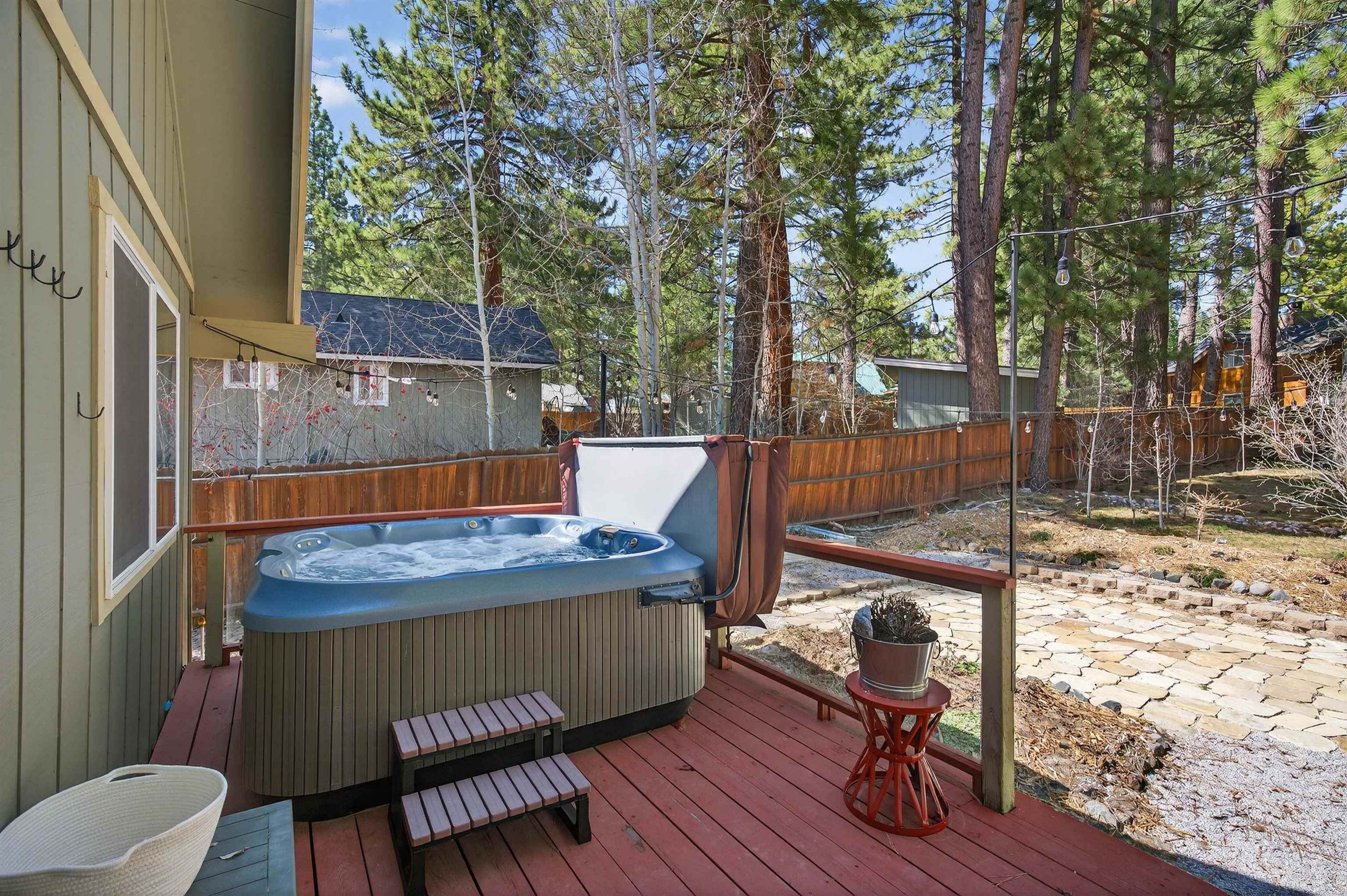 10220 Columbine Road Truckee, CA 96161 - Photo 13 of 28 a view of a patio with table and chairs with wooden floor and fence