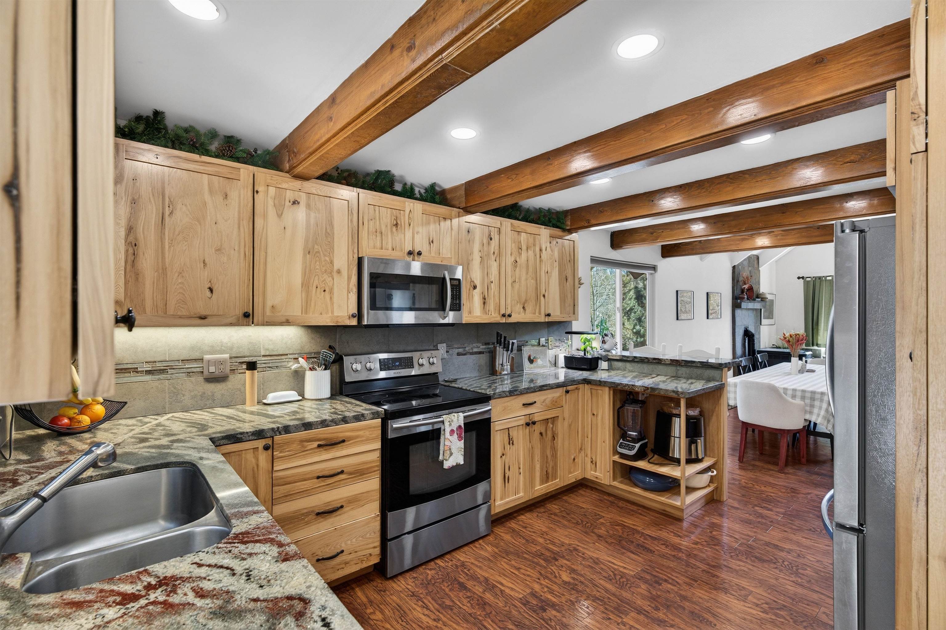 10220 Columbine Road Truckee, CA 96161 - Photo 14 of 28 a kitchen with stainless steel appliances a stove sink and cabinets