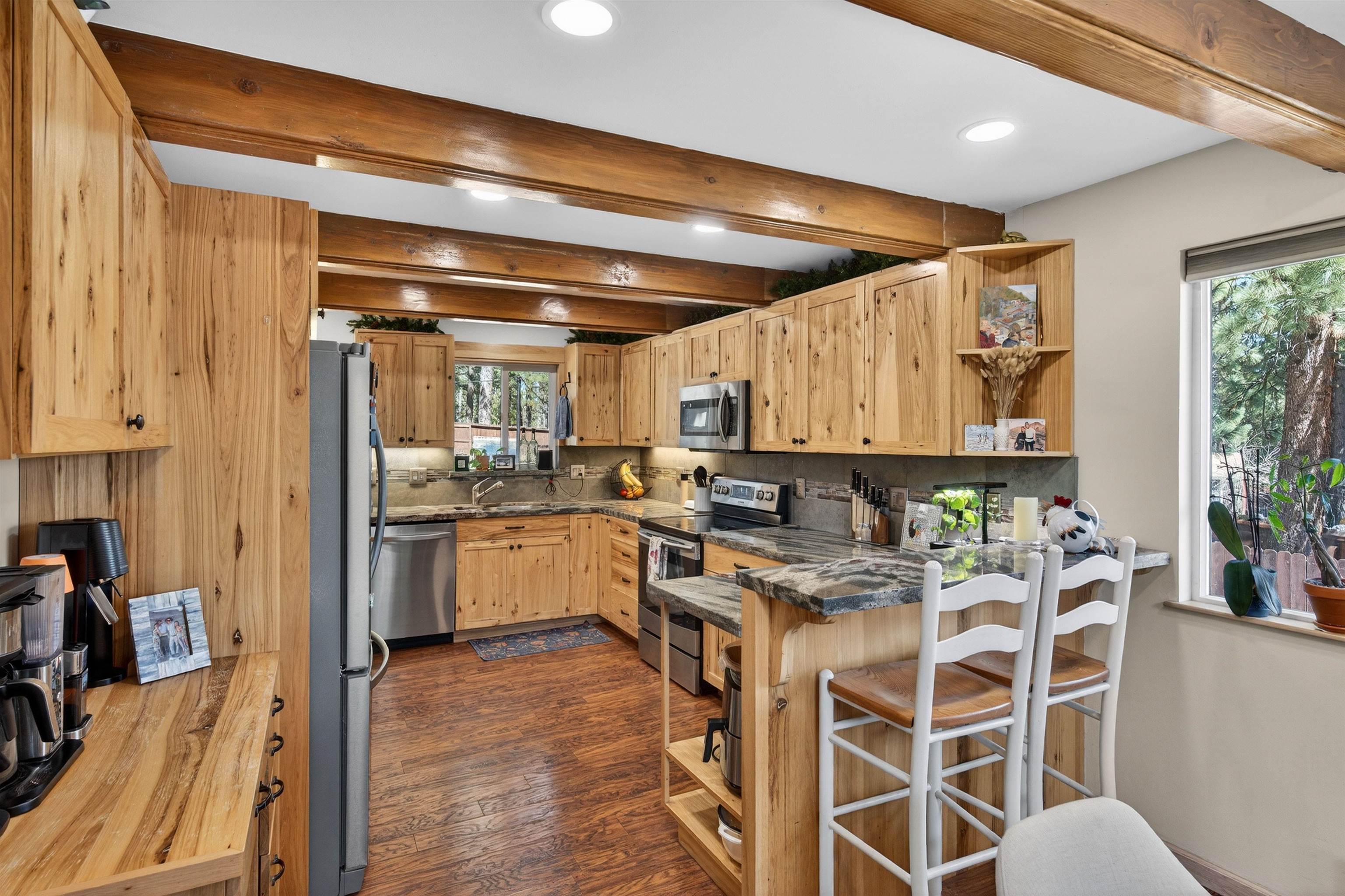 10220 Columbine Road Truckee, CA 96161 - Photo 15 of 28 a kitchen with stainless steel appliances kitchen island granite countertop a table chairs sink and cabinets