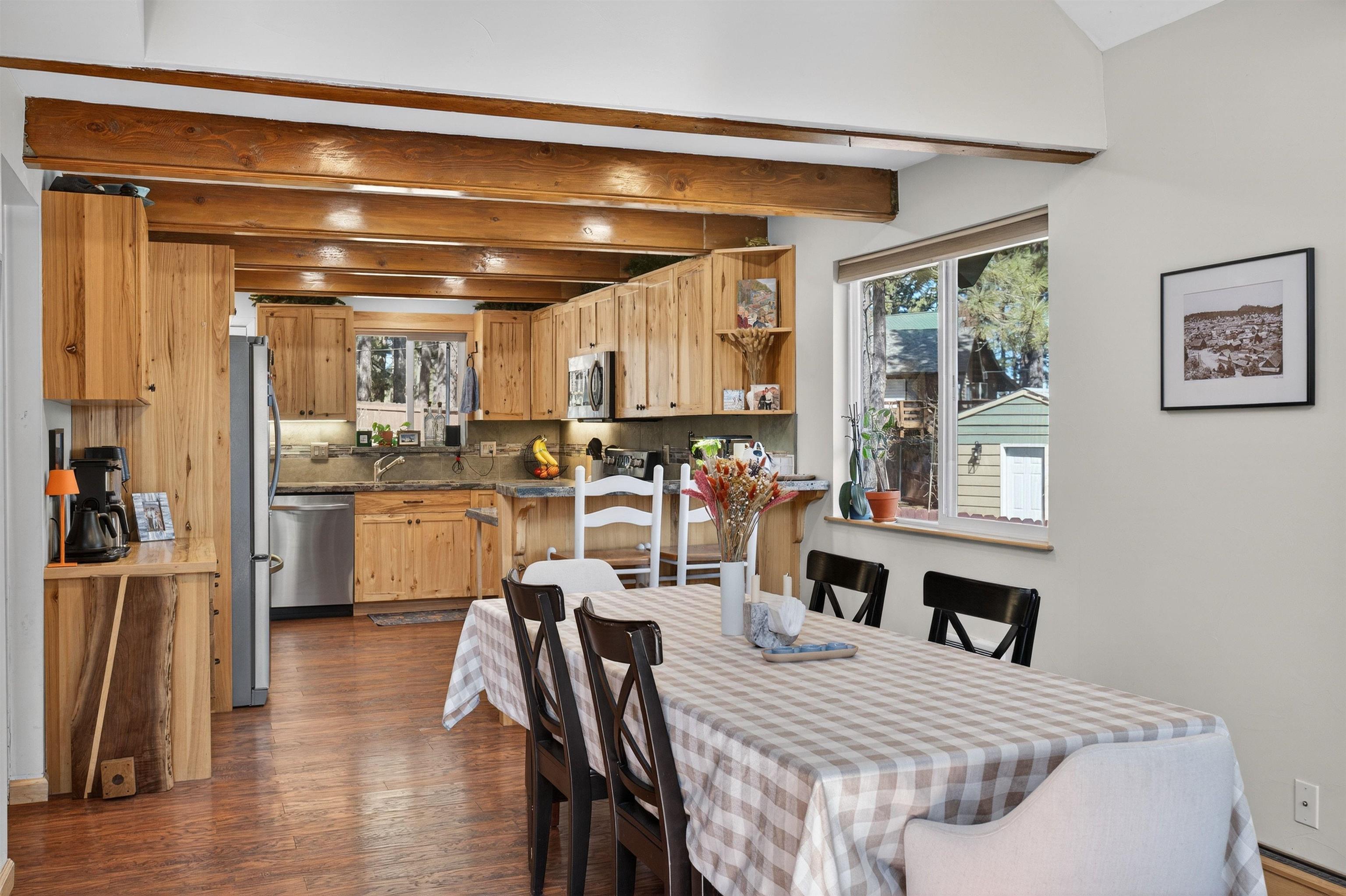 10220 Columbine Road Truckee, CA 96161 - Photo 17 of 28 a kitchen with a table chairs refrigerator and cabinets