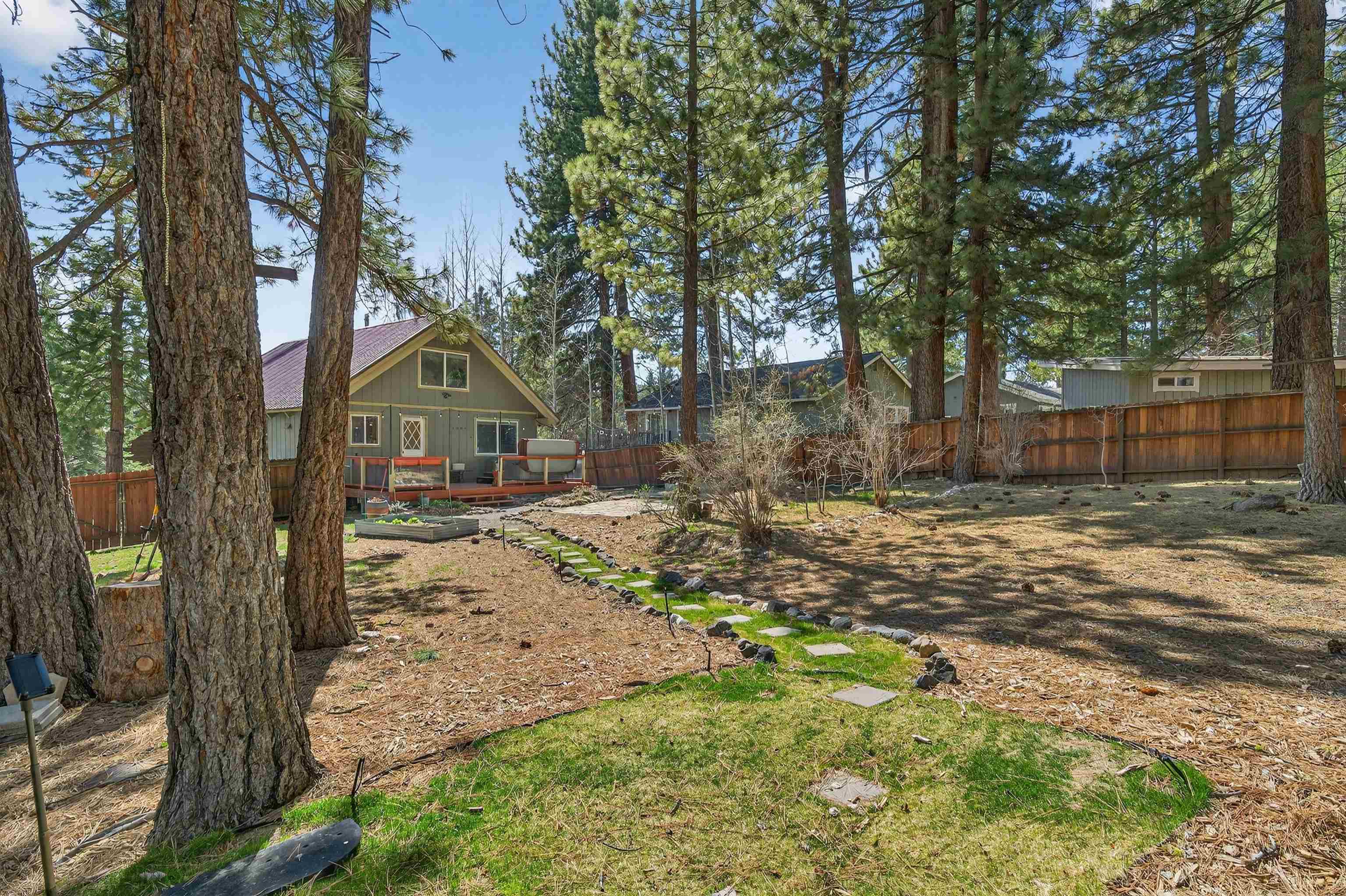 10220 Columbine Road Truckee, CA 96161 - Photo 26 of 28 a view of a yard with large tree and wooden fence
