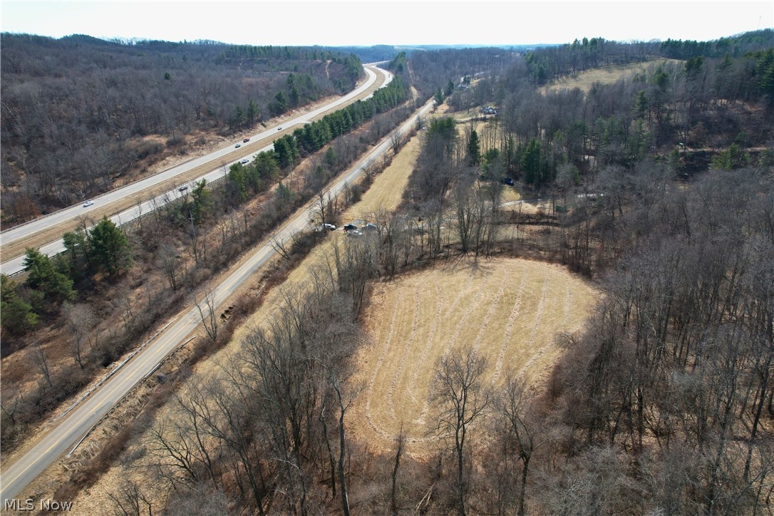 Stonecreek Road Newcomerstown, OH 43832 - Photo 5 of 14 Expansive aerial view showcasing wooded areas, a cleared field, and a highway