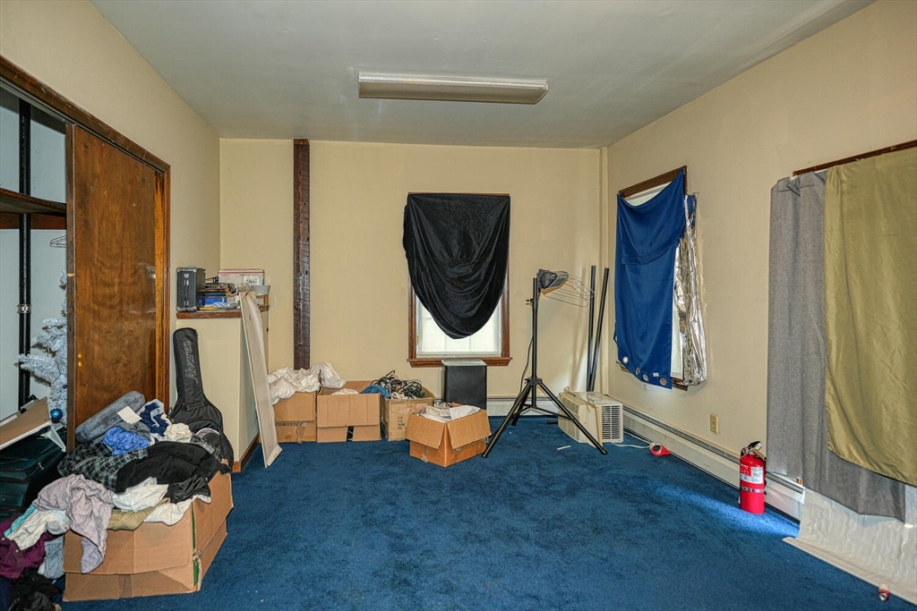 7 Prospect Street Woburn, MA 01801 - Photo 27 of 41 a living room with furniture and a painting on the wall