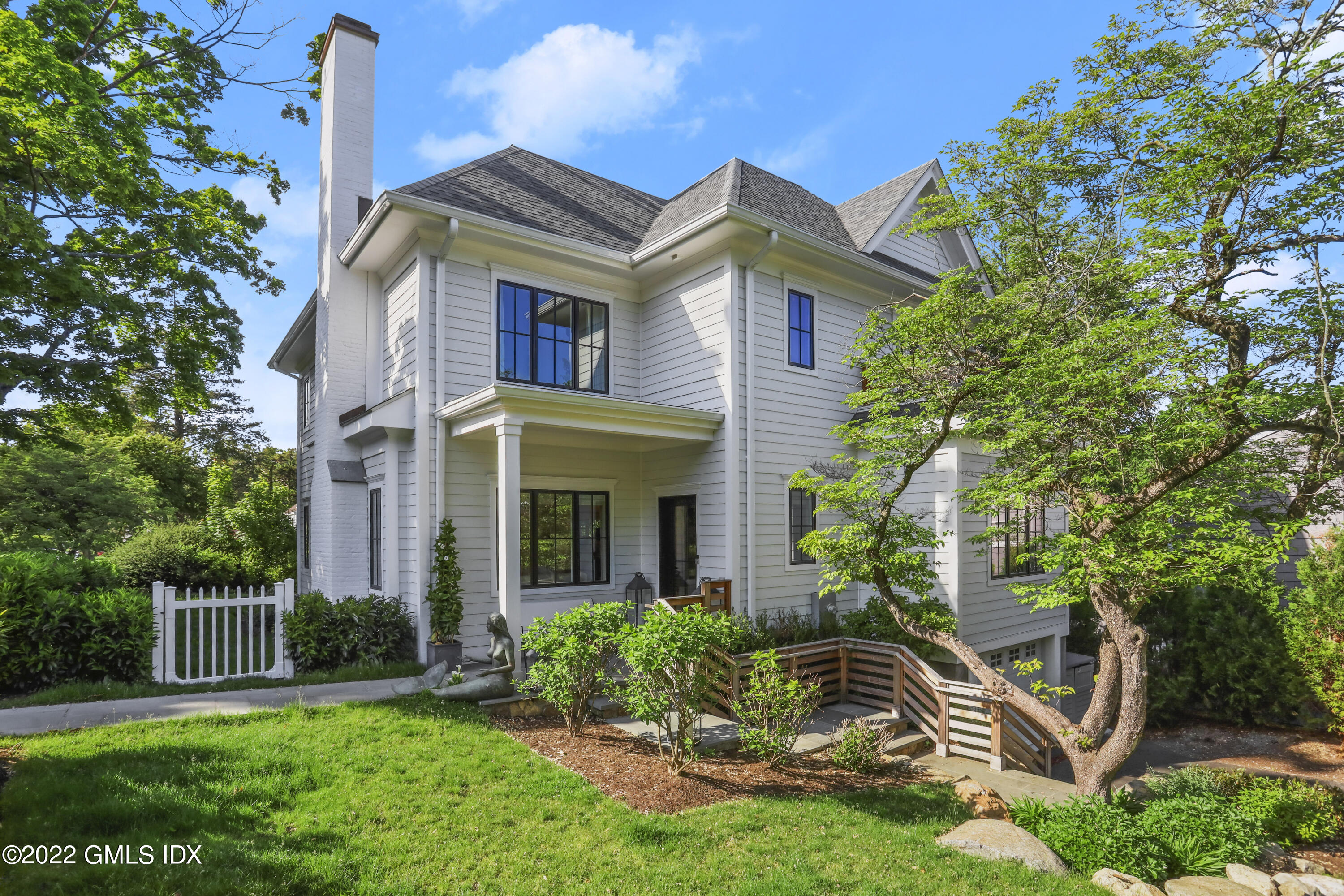 27 Linwood Avenue Riverside, CT 06878 - Photo 1 of 23 a front view of a house with a yard and trees