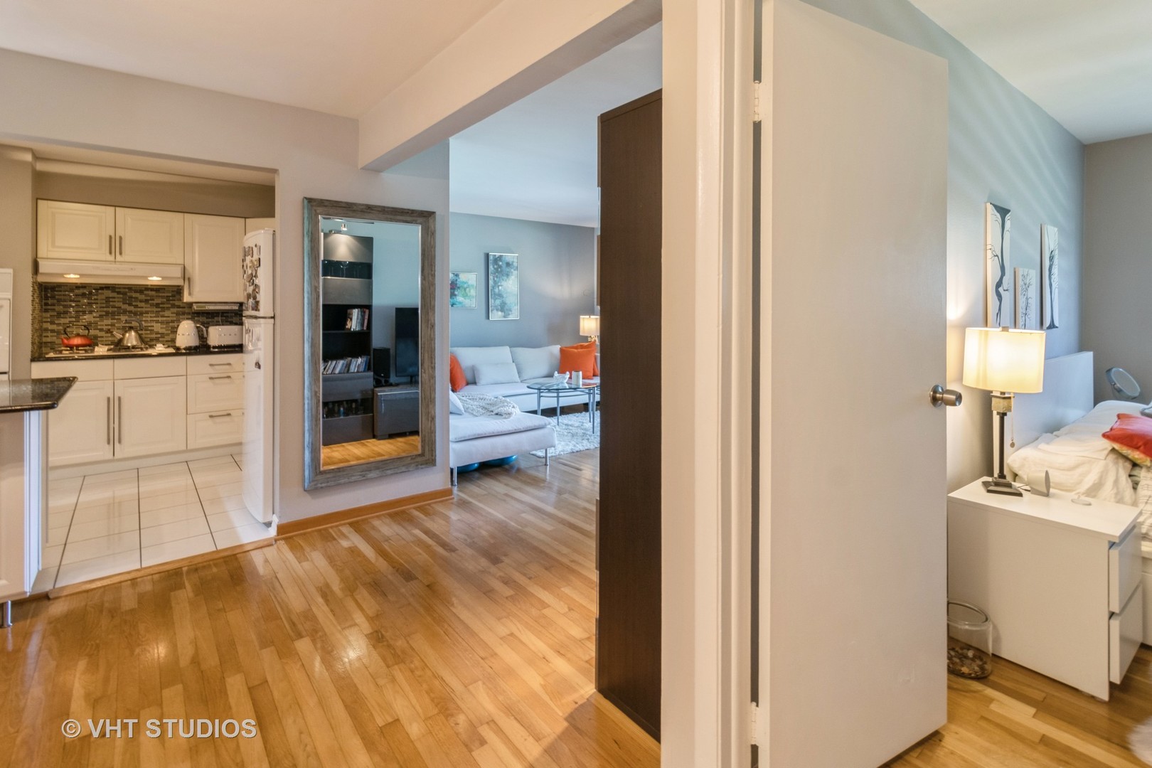 9500 Dee Road, Unit 106F Des Plaines, IL 60016 - Photo 21 of 28 a view of a room that has a bed and wooden floor