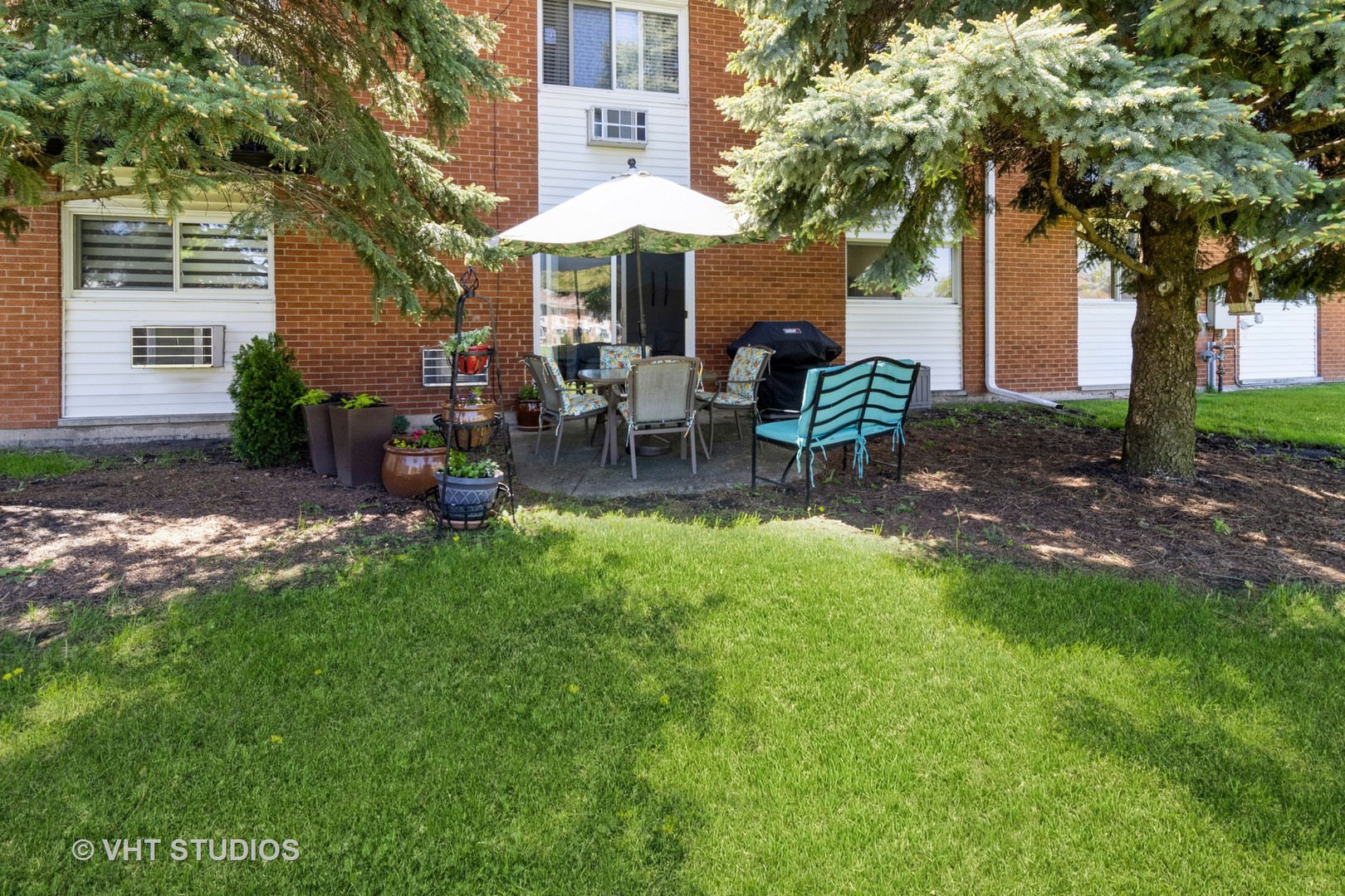 9500 Dee Road, Unit 106F Des Plaines, IL 60016 - Photo 23 of 28 a view of a house with a backyard and sitting area