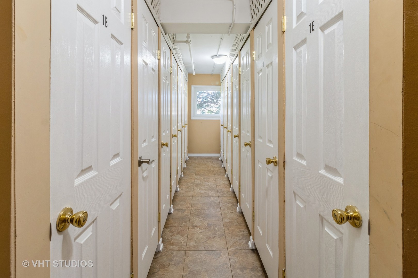 9500 Dee Road, Unit 106F Des Plaines, IL 60016 - Photo 27 of 28 a view of a hallway with wooden floor and a glass door