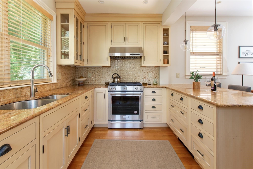 17 Coolidge Street Brookline, MA 02446 - Photo 13 of 41 a kitchen with stainless steel appliances a stove sink and cabinets