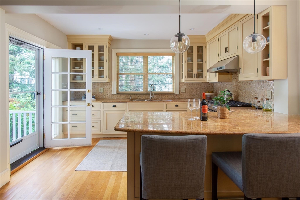 17 Coolidge Street Brookline, MA 02446 - Photo 14 of 41 a kitchen with stainless steel appliances granite countertop wooden floors and sink