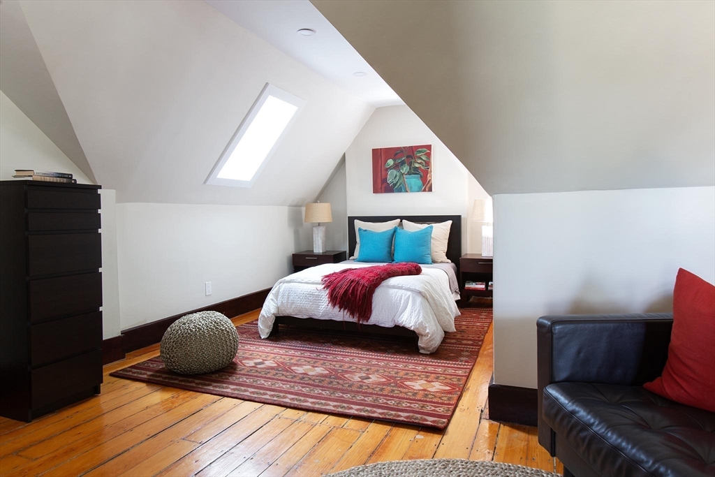 17 Coolidge Street Brookline, MA 02446 - Photo 26 of 41 a bedroom with a bed and wooden floor