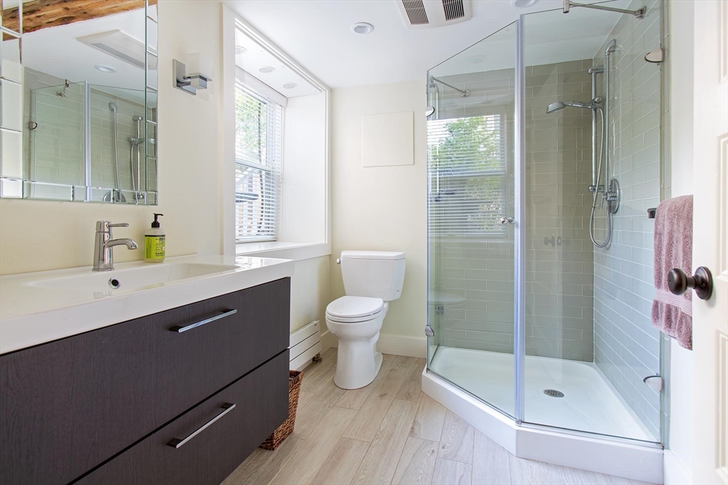 17 Coolidge Street Brookline, MA 02446 - Photo 32 of 41 a bathroom with a shower sink vanity mirror and toilet