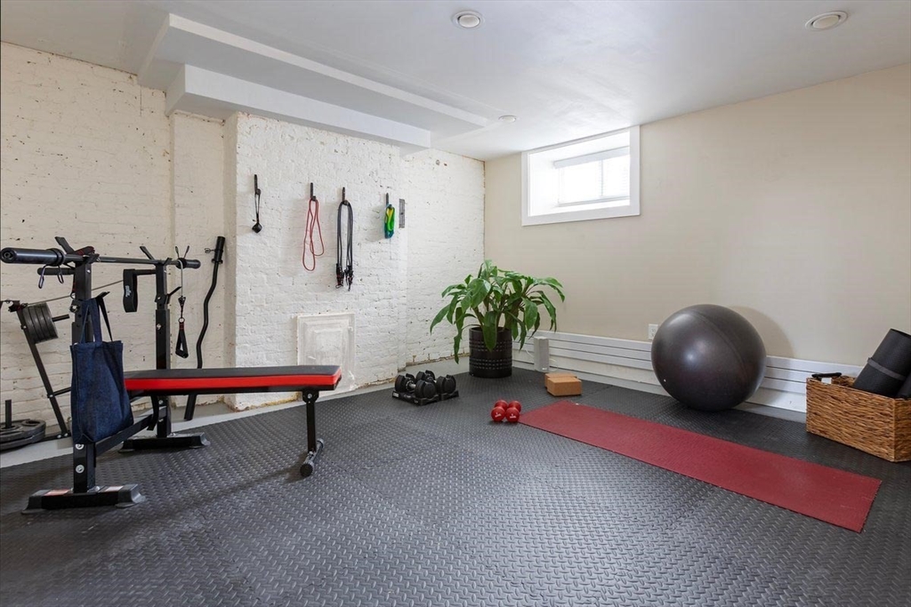 17 Coolidge Street Brookline, MA 02446 - Photo 36 of 41 a living room with furniture and gym equipment