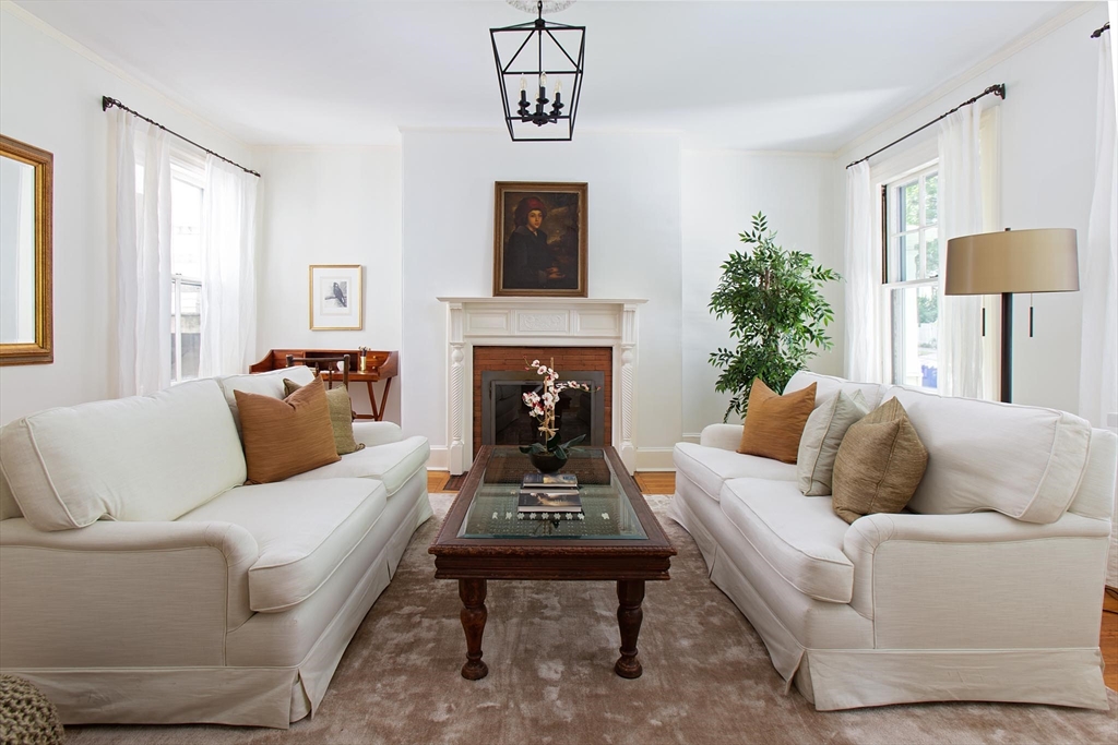 17 Coolidge Street Brookline, MA 02446 - Photo 8 of 41 a living room with furniture and a fireplace