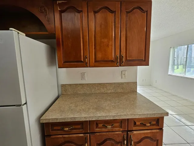 a kitchen with a refrigerator and a stove