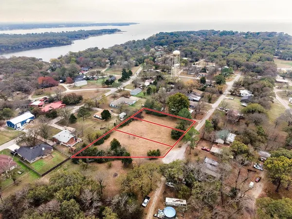 an aerial view of residential houses with outdoor space and ocean view