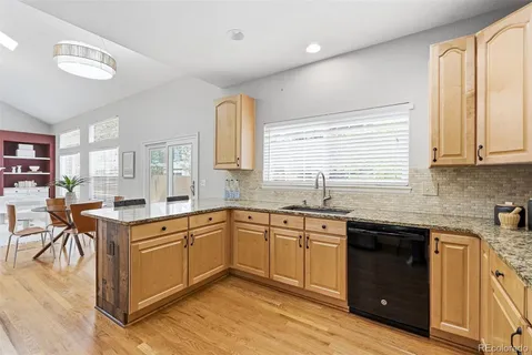 a kitchen with a sink stove and cabinets