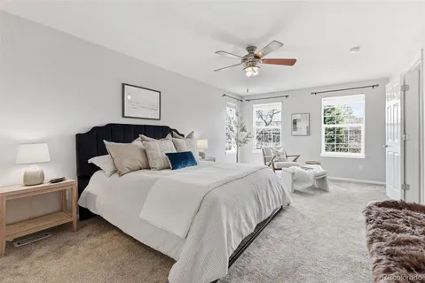 a spacious bedroom with a bed couch and a window