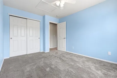 a view of walk in closet with empty racks