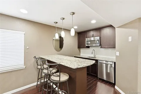 a kitchen with sink microwave and stove