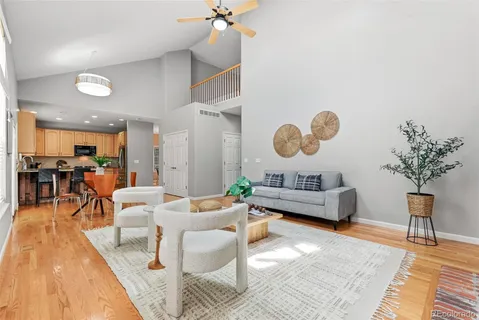 a living room with furniture and a chandelier