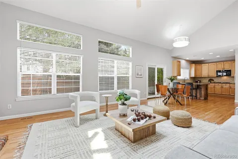 a living room with furniture and floor to ceiling windows