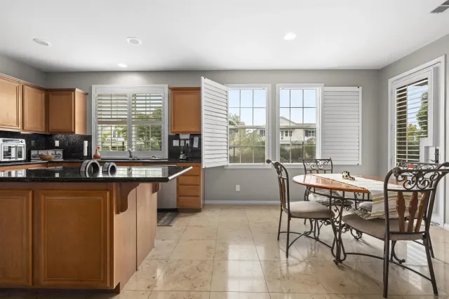 a kitchen with stainless steel appliances granite countertop a stove sink and cabinets