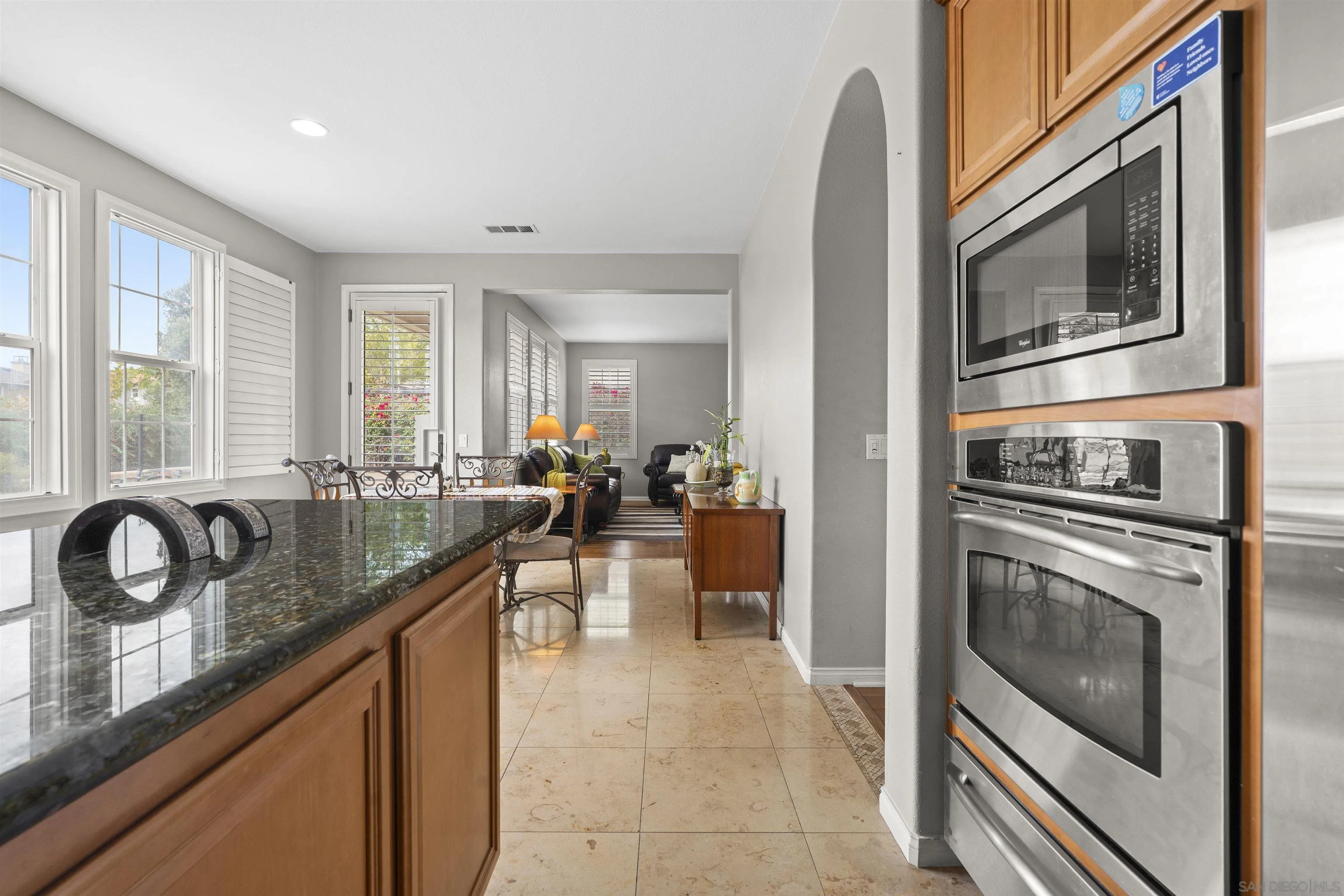 840 Luminara Way San Marcos, CA 92078 - Photo 13 of 57 a kitchen with stainless steel appliances granite countertop a stove and a sink