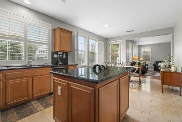a kitchen with sink and view of living room