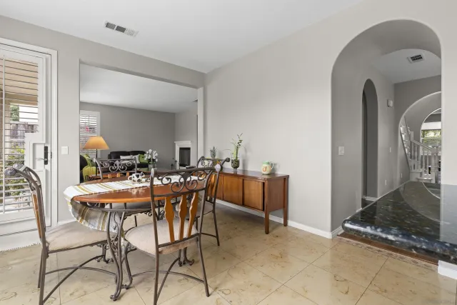 a view of a dining room with furniture and windows
