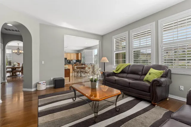 a living room with furniture and a floor to ceiling window