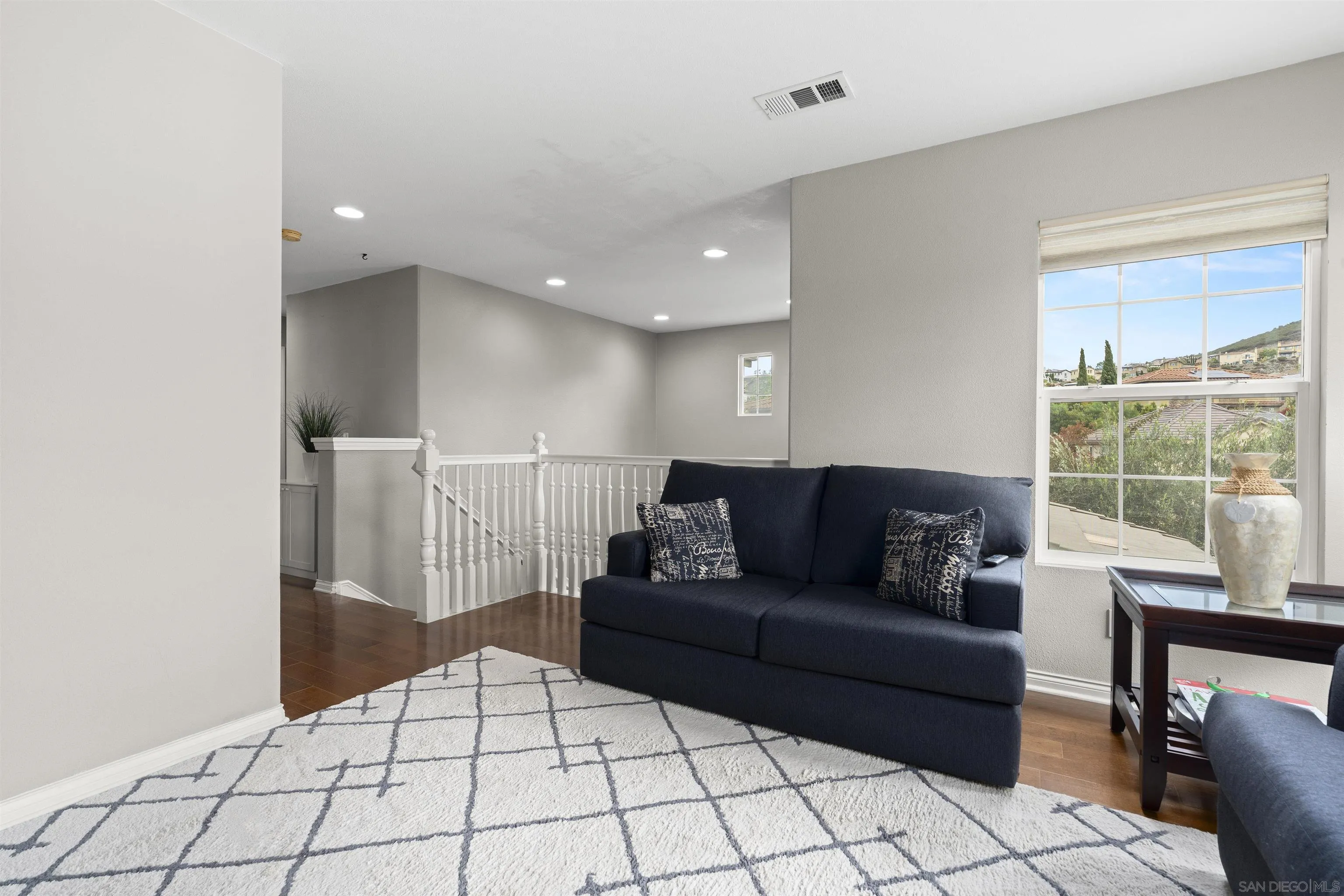 840 Luminara Way San Marcos, CA 92078 - Photo 26 of 57 a living room with furniture and a floor to ceiling window