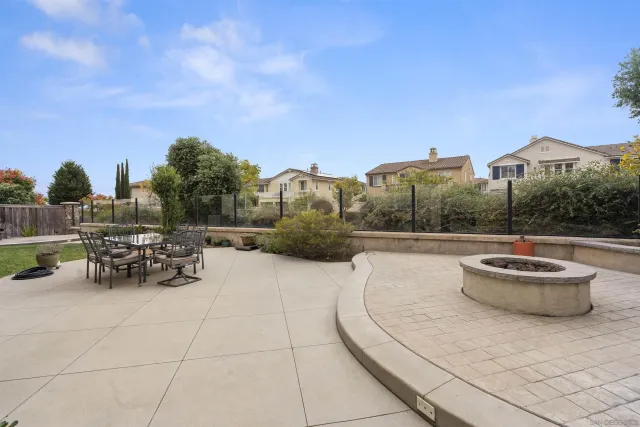 a pathway of a house with potted plants