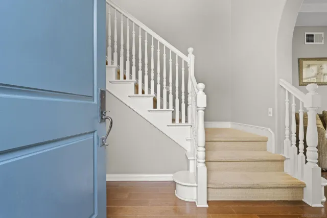 a view of entryway and hall with wooden floor